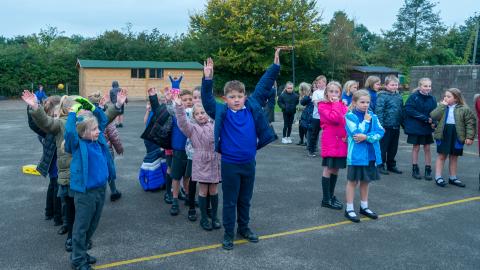 People in the playground lining up to come back indoors